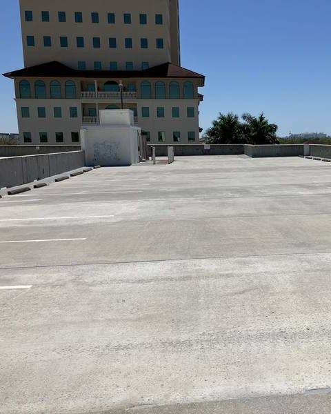 The same parking garage top deck after pressure washing, clean and even