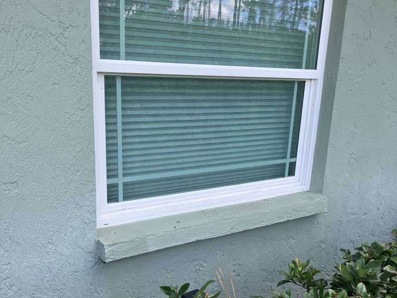 The same style of window with a clean white frame and clean sill